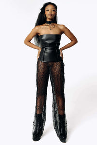 Frontal  side view of Cameron wearing the Harvestman Wide Leg Sheer Pants with sheer black mesh covering the entire leg from SCATHED's Fall Winter 2025 Reaper collection.
