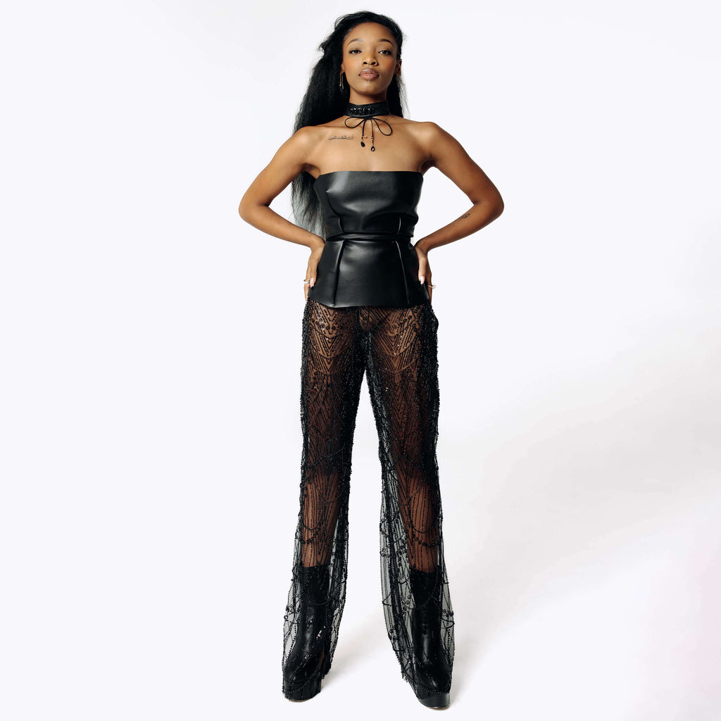 Frontal  side view of Cameron wearing the Harvestman Wide Leg Sheer Pants with sheer black mesh covering the entire leg from SCATHED's Fall Winter 2025 Reaper collection.