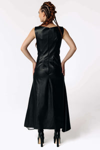 Back view of Caitlin wearing the Kalma Cactus Leather Maxi Dress, a full-length black leather dress that flares out from the hips from SCATHED's Fall Winter 2025 Reaper collection.
