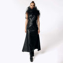 Front view of Caitlin wearing the Kalma Cactus Leather Maxi Dress, a full-length black leather dress that flares out from the hips with the Wraith Black Tulle Collar from SCATHED's Fall Winter 2025 Reaper collection. Caitlin also wears high-heeled black platformed ankle boots.