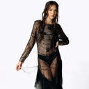 Frontal portrait view of Eliza wearing the Morta Beaded Cross Fringe Dress featuring beaded embellishments and sheer layered with fringe from SCATHED's Fall Winter 2025 Reaper collection.