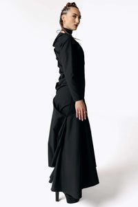 Side view of Caitlin facing camera while wearing the Nox Black Cotton Skeleton Dress from SCATHED's Fall Winter 2025 Reaper collection.