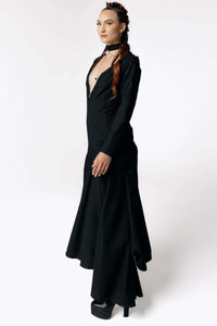 Side view of Caitlin facing camera while wearing the Nox Black Cotton Skeleton Dress with a plunging neckline from SCATHED's Fall Winter 2025 Reaper collection.