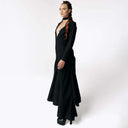 Side view of Caitlin facing camera while wearing the Nox Black Cotton Skeleton Dress with a plunging neckline from SCATHED's Fall Winter 2025 Reaper collection.