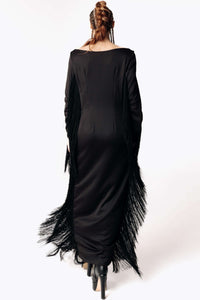 Back view of Caitlin wearing the Revenant Black Dress with fringed sleeves and hem from SCATHED's Fall Winter 2025 Reaper collection.