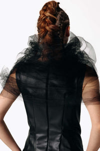 Close-up back view of Caitlin wearing the Wraith Collar, a sheer black tulle shoulder shrug, with the Kalma Cactus Leather Maxi Dress from SCATHED's Fall Winter 2025 Reaper collection.