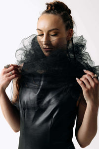 Close-up view of Caitlin wearing the Wraith Collar, a sheer black tulle shoulder shrug, with the Kalma Cactus Leather Maxi Dress from SCATHED's Fall Winter 2025 Reaper collection.