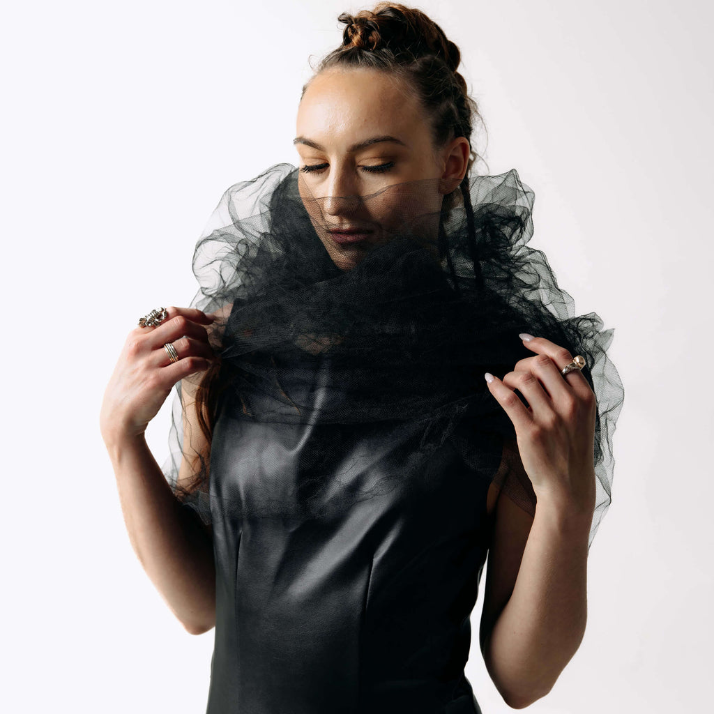 Close-up view of Caitlin wearing the Wraith Collar, a sheer black tulle shoulder shrug, with the Kalma Cactus Leather Maxi Dress from SCATHED's Fall Winter 2025 Reaper collection.