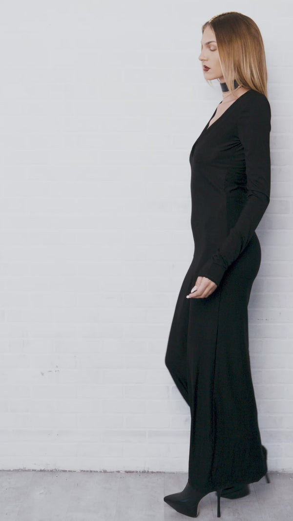 Video of model wearing the Hollows long maxi black dress with low v neckline showing front, back, and side view