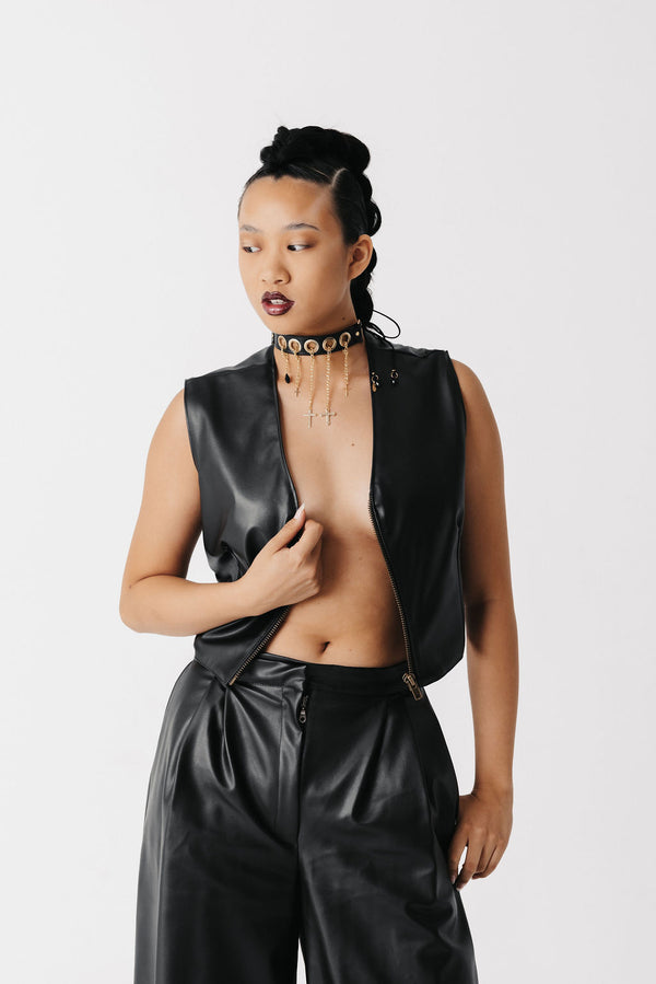 Video of model wearing adjustable cactus leather vest and wide leg cactus leather pants with leather necklace and cross charms