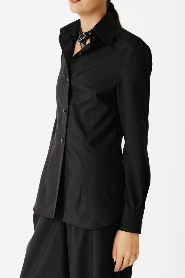 Video of model wearing a black bamboo cotton button up shirt with skull buttons and black wide leg trousers showing front side and back view.