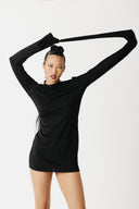 Video of model showing jersey black shirt with extra long sleeves styled as a mini dress showing front, side, and back view