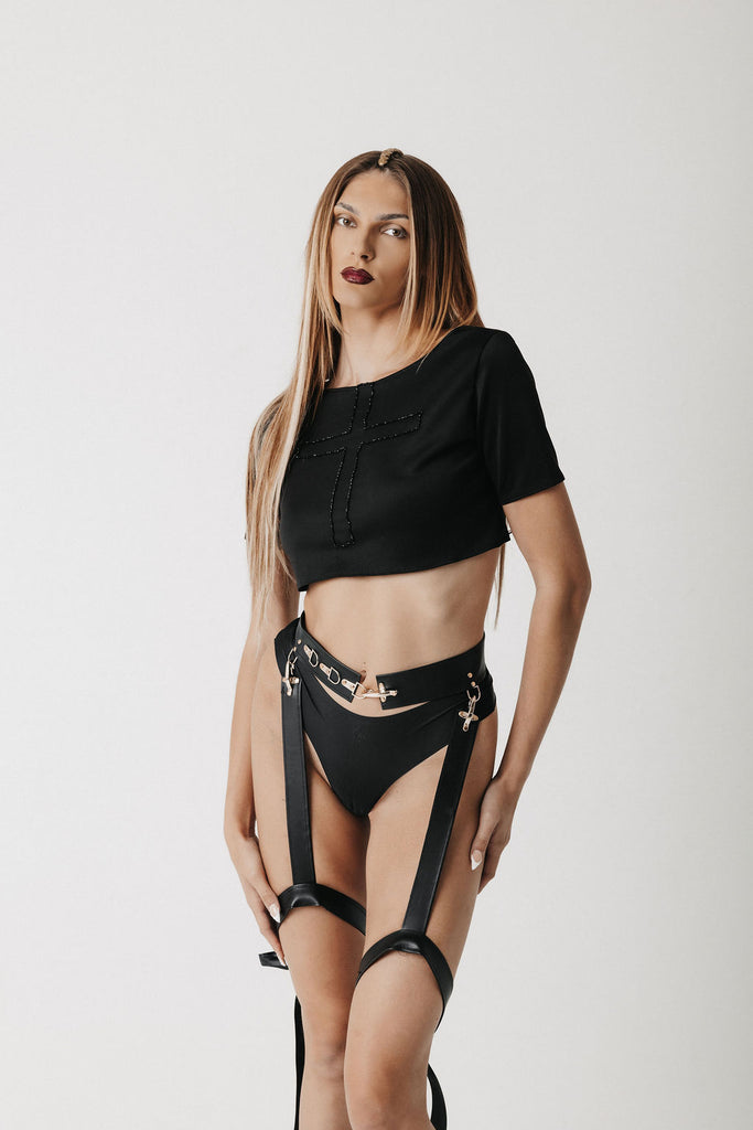 Video of model wearing cactus leather garter-belt style belt and crop T-shirt showing front, side, and back view