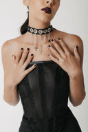 Model shows cactus leather choker with silver cross charms wearing a black corset and black midi skirt