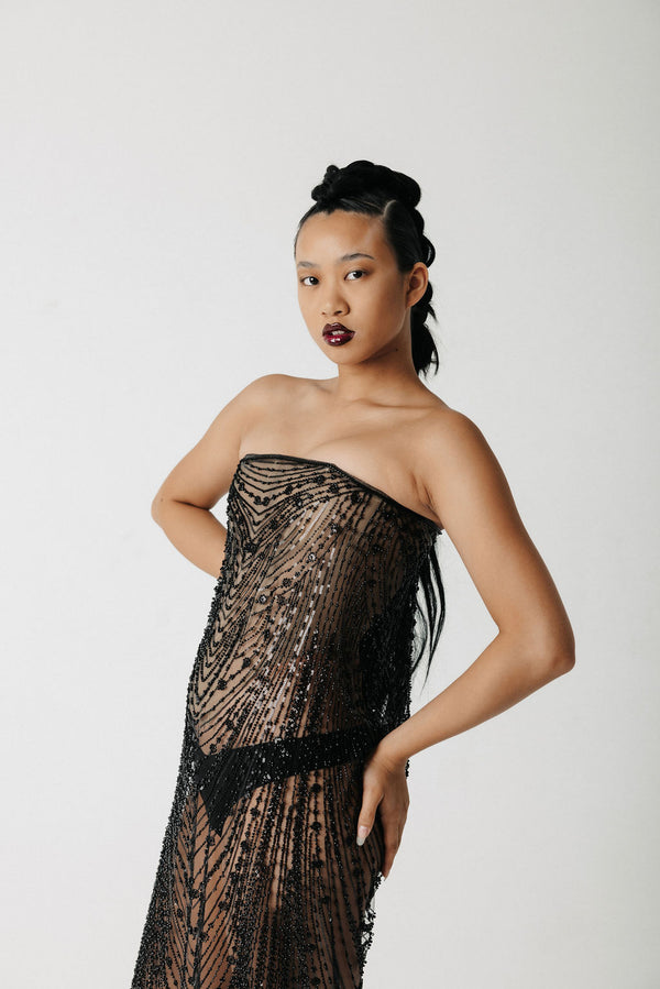 Video of model showing front, side, and back view of a beaded, strapless dress with a corset base and lace up back
