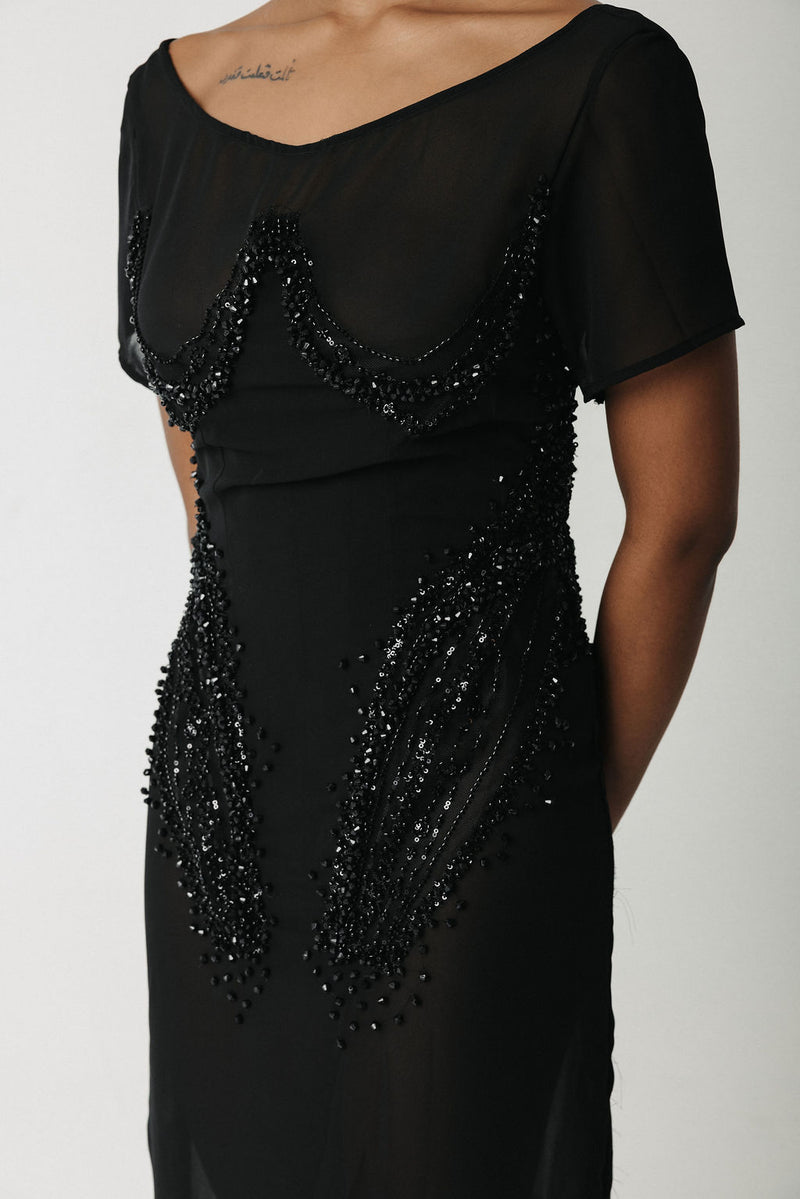 Close-up of hand-beaded black chiffon gown bodice with built-in corset detail