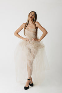 Model wearing strapless nude eco-tulle gown with structured corset, front view