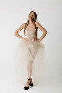Model wearing strapless nude eco-tulle gown with structured corset, front view