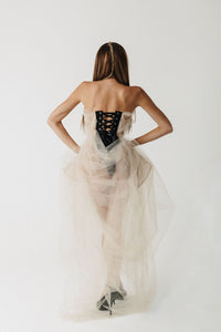 Back view of eco-tulle gown showing exposed black lace-up corset detail