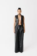 Model wearing black cactus leather zip-front vest, open, with matching wide-leg cactus leather trousers, front view