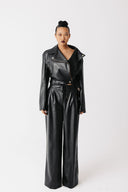 Front view of model wearing cactus leather moto jacket with matching wide-leg trousers