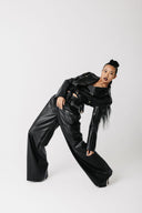 Side angle of cactus leather motorcycle jacket showing cropped hem and lapel detail