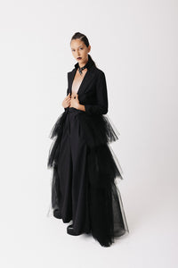 Model wearing The Boleyn Jacket, a cropped cotton jacket with tiered eco-tulle train, side view