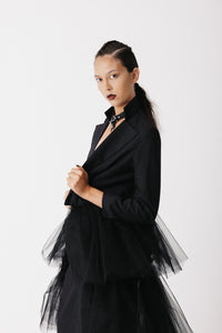 Model wearing The Boleyn Jacket open over a leather choker, cropped jacket with tulle train close up