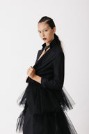 Model wearing The Boleyn Jacket open over a leather choker, cropped jacket with tulle train close up