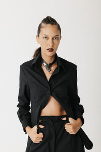 Model wearing the Mourner Shirt styled with black wide-leg trousers and a leather choke