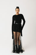 Model wearing the Shroud Skirt, a sheer beaded eco-tulle overlay layered over a mini skirt, extending to the floor