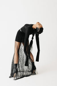 back view of the Shroud beaded Skirt showing radiating beaded pattern on sheer tulle, worn as a layering piece on model in dynamic posing