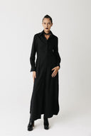 Model wearing the Widow Shirt Dress, a floor-length black button-down shirt dress in organic bamboo cotton