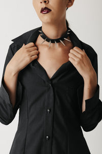 Close-up of the Fang Choker, a spiked cactus leather choker with silver studs, worn with an open blazer