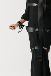 Close up view of The Stuart Harness showing the cross-formation strap layout and hook hardware