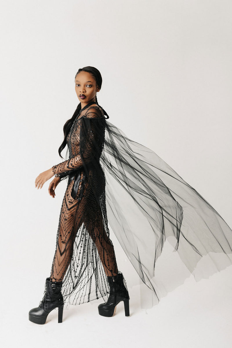 Side view of The Tamar Gown showing the beaded ribbon harness overlay and trailing tulle sleeve