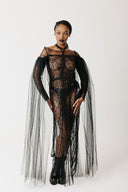 Model wearing The Tamar Gown, a beaded sheer gown with floor-length eco-tulle sleeves, front view