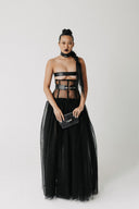 Model wearing The Tomyris Skirt, a black eco-tulle skirt with boned corset waistband