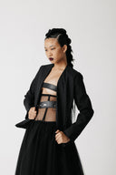 Front view of model wearing the Onyx Blazer open over a sheer corset top and spiked choker