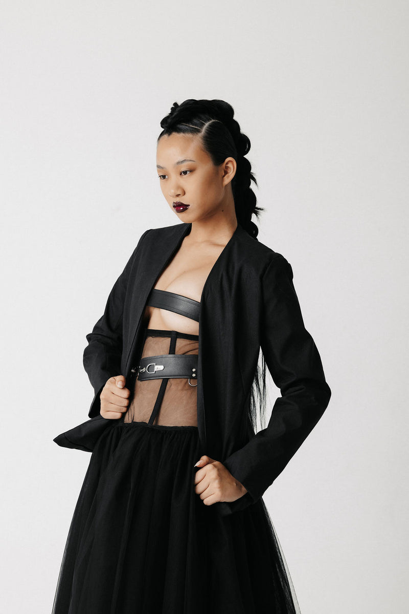 Front view of model wearing the Onyx Blazer open over a sheer corset top and spiked choker
