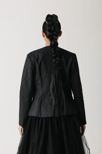 Back view of the Onyx Blazer showing its collarless neckline and structured shoulder