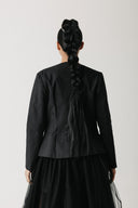Back view of the Onyx Blazer showing its collarless neckline and structured shoulder
