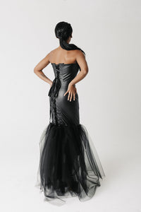 Back view of the Matilda Gown showing the lace-up corset closure with branded ribbon and tulle mermaid hem
