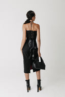 Back view of the Solace Skirt showing its longer hem and back slit. Worn with black lace up corset