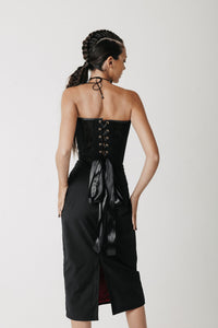 Back view of the Solace Skirt showing its longer hem and back slit