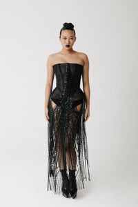 Front view of model wearing the Boudica Gown, a strapless corset dress with hand-beaded fringe cascading down the front