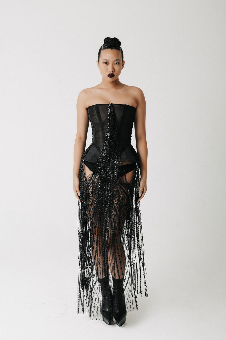 Front view of model wearing the Boudica Gown, a strapless corset dress with hand-beaded fringe cascading down the front