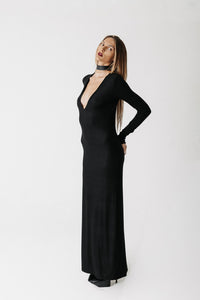 Side view of model wearing the Hollow Dress showing the structured shoulder and V neckline
