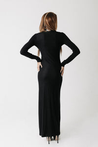 Back view of the Hollow Dress showing the fitted silhouette and floor length hem