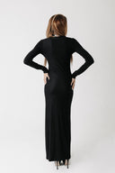 Back view of the Hollow Dress showing the fitted silhouette and floor length hem